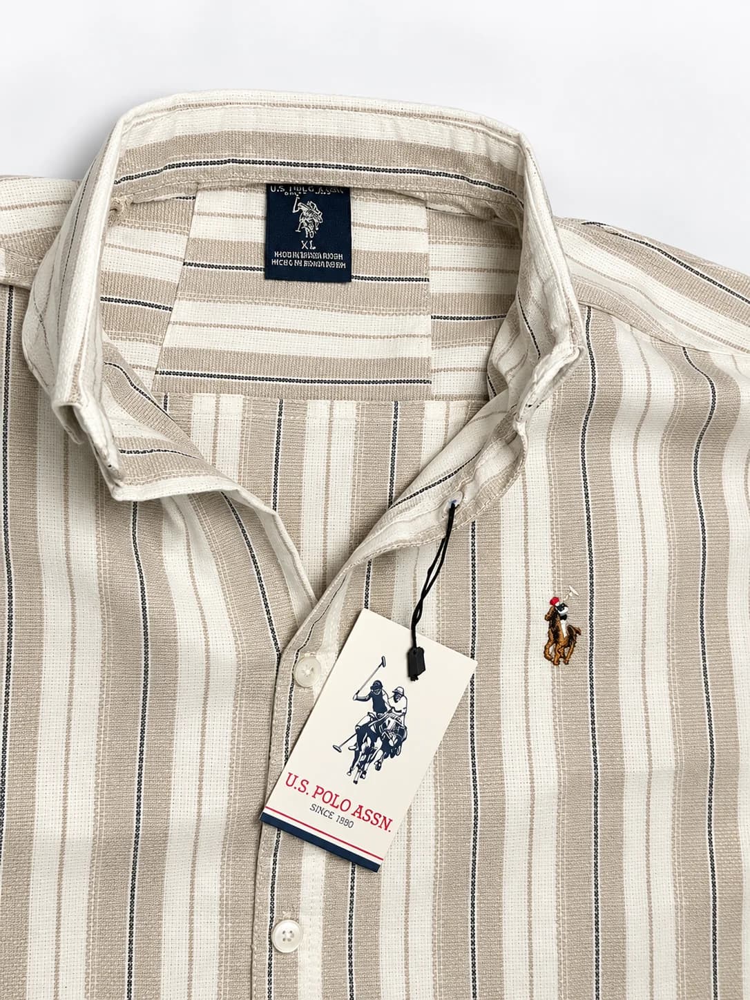 U.S. Polo Assn. Men's Beige and Cream Vertical Striped Full Sleeve Shirt with Black Pinstripes, White Buttons and Embroidered Polo Player Logo
